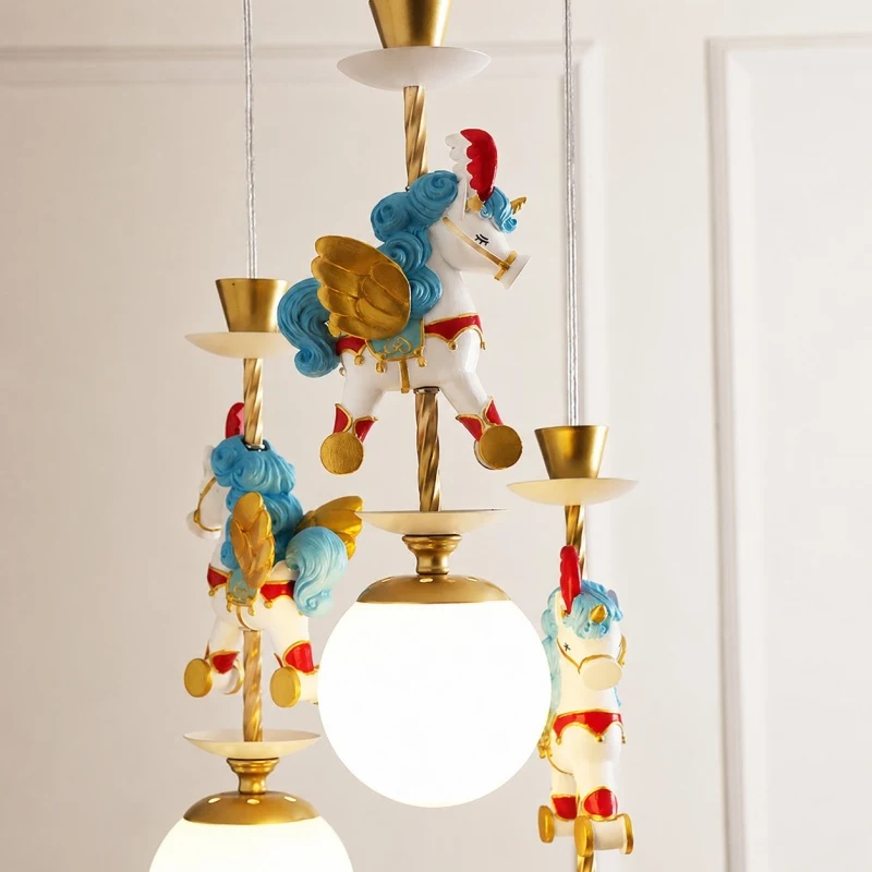 Close up of blue unicorn ornament beside illuminated globe shade
