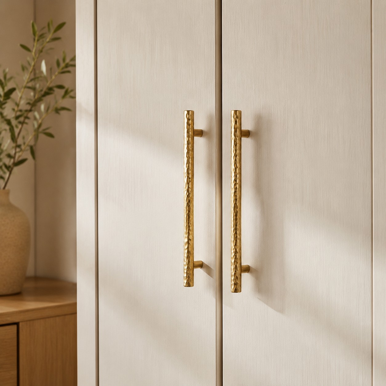 Natural Brass hammered bar pulls installed on wardrobe doors