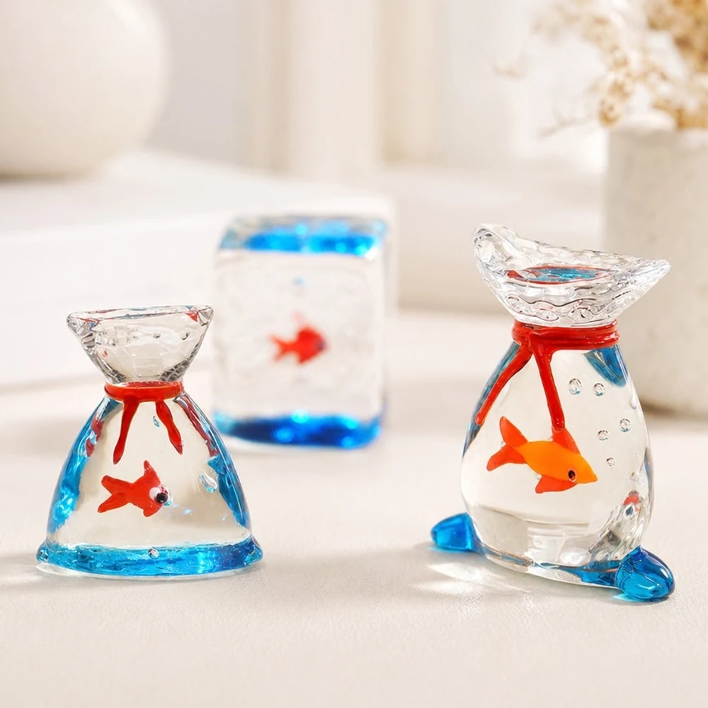 Glass goldfish ornaments styled on a bright shelf