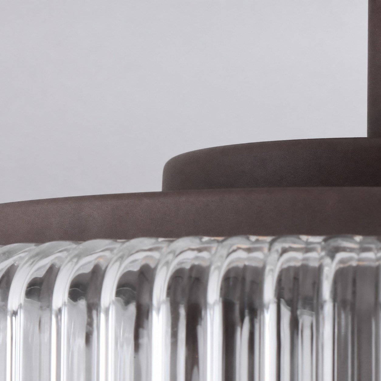 Close-up of metal canopy and ribbed glass edge